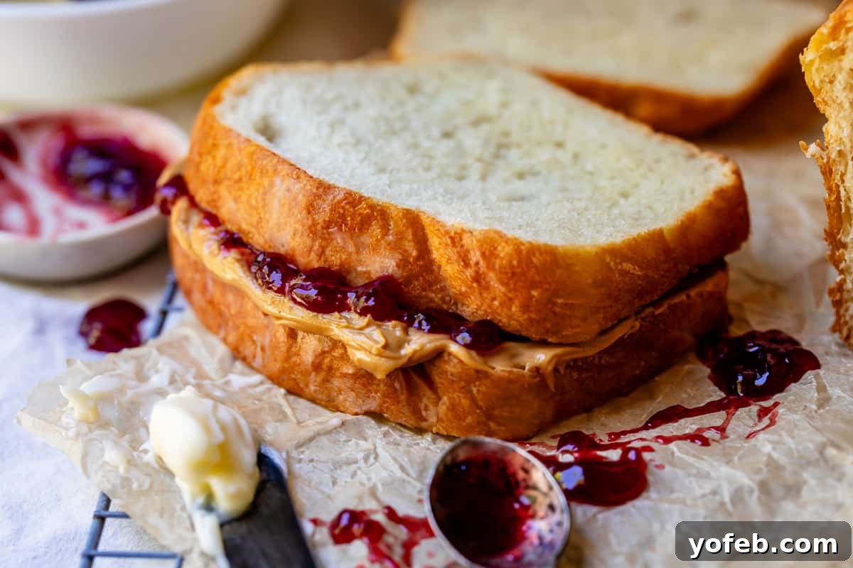 The White Bread Recipe That Ends Your Search 27 A close-up of a classic peanut butter and jelly sandwich, made with thick, soft slices of homemade white bread.