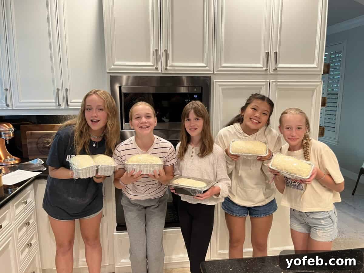The White Bread Recipe That Ends Your Search 5 Five smiling girls in a kitchen, proudly holding pans of their perfectly rising homemade bread dough.