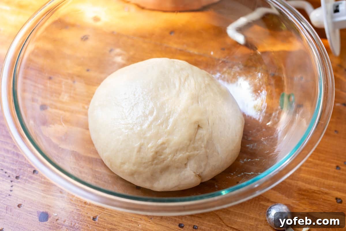 Decadent Bavarian Cream Donuts 10 ball of Bavarian cream donut dough rising in a greased glass bowl.