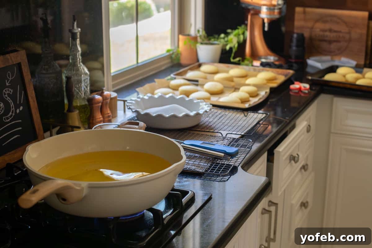 Decadent Bavarian Cream Donuts 17 fry station all ready to go - hot oil, cooling rack, sugar for coating, risen donuts, etc.