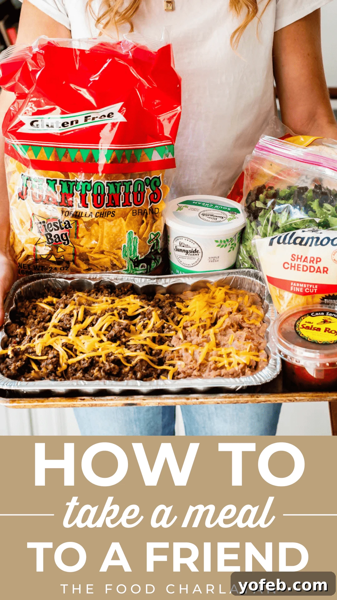 Cooking Up Kindness: Delivering Meals to Loved Ones 2 Woman holding a tray of taco ingredients including taco meat, beans, chips, salsa, and cheese, showcasing a ready-to-serve meal kit.