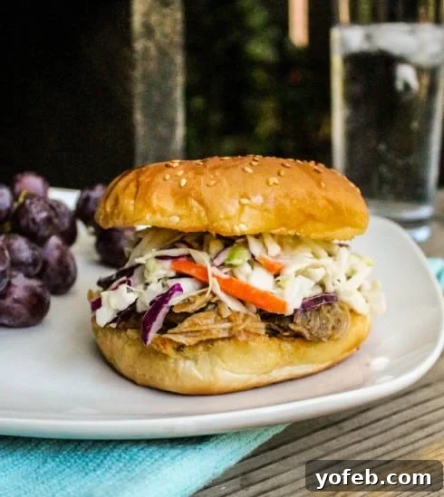 Juicy Pulled Pork with Peaches served on a sandwich