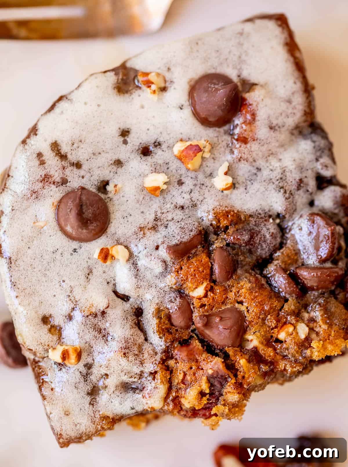 Picnic Perfection: Buttermilk Glazed Cake 10 close up of a cut piece of picnic cake showing the glaze, chocolate chips, and more.
