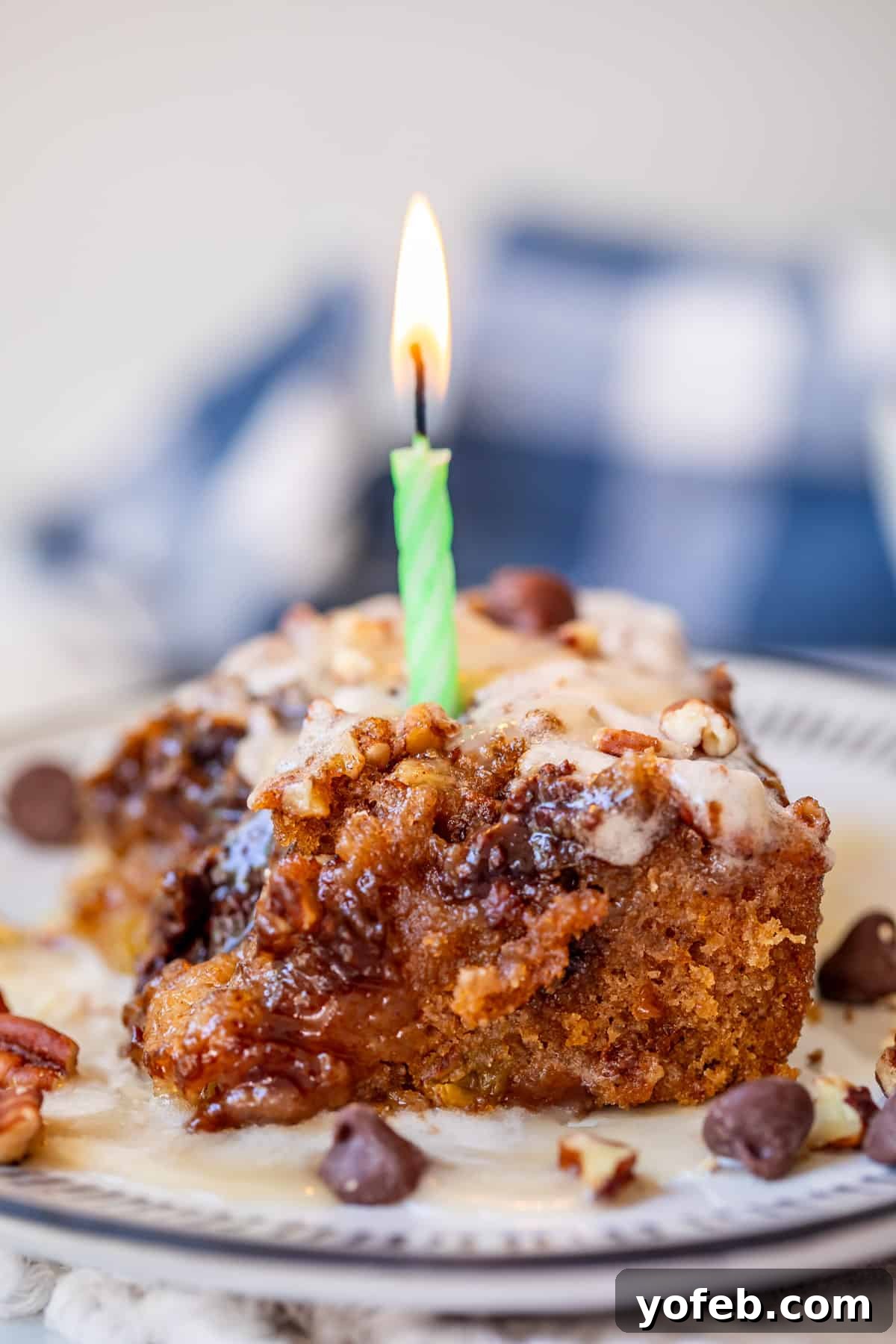 Picnic Perfection: Buttermilk Glazed Cake 3 piece of picnic cake on a plate with a lit birthday candle in it representing 12th anniversary of blogging.