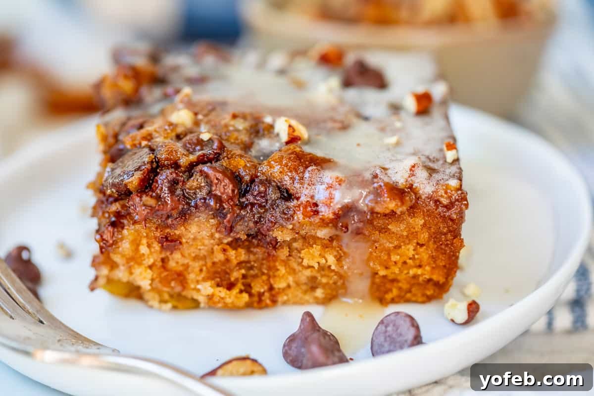 Picnic Perfection: Buttermilk Glazed Cake 7 horizontal view showing layers of a cut piece of picnic cake on a plate with a fork.