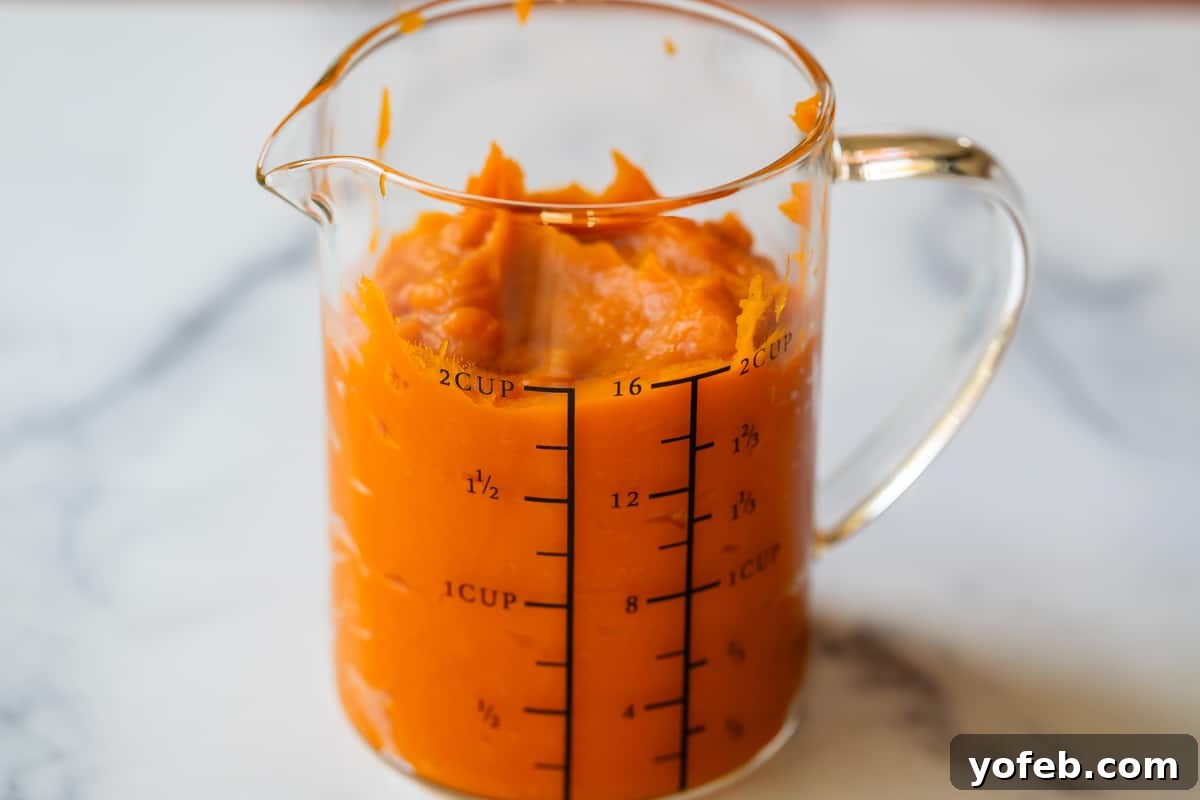 Golden Sweet Potato Pie Crowned with Salted Caramel Cream 18 smooth, whipped sweet potato in a measuring cup, showing 2 cups measured.