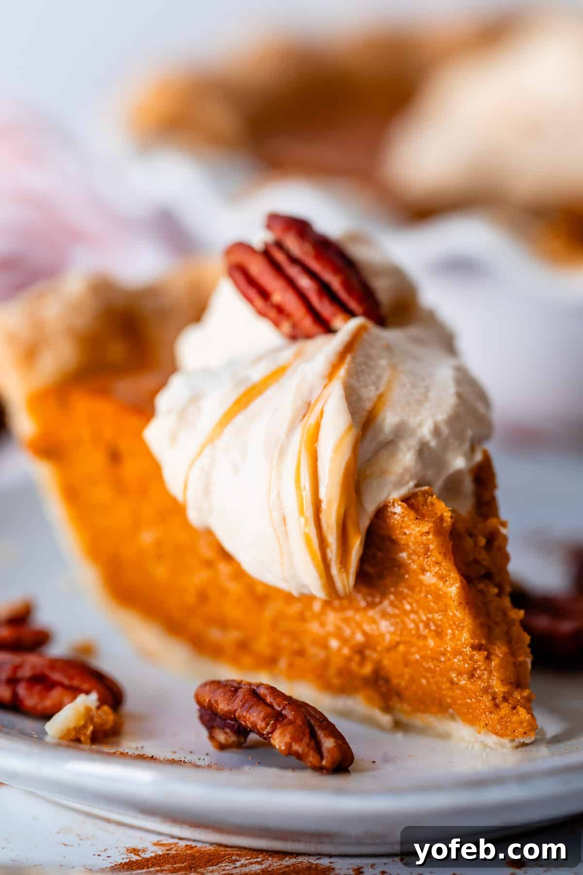 Golden Sweet Potato Pie Crowned with Salted Caramel Cream 3 fork digging into a slice of southern sweet potato pie with a delicious salted caramel whipped cream.