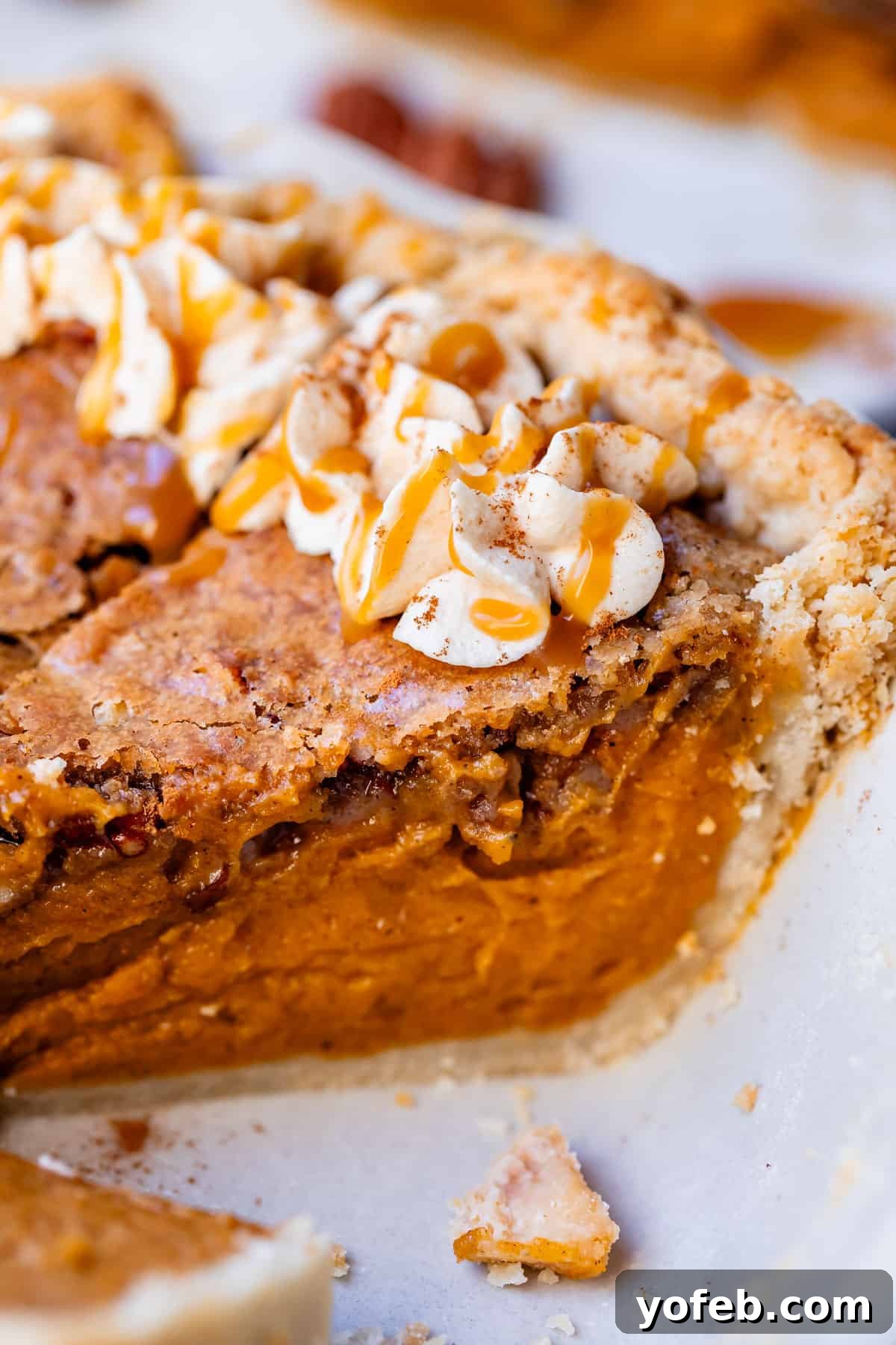 Golden Sweet Potato Pie Crowned with Salted Caramel Cream 4 side view of pie with praline topping baked into it, with dollop of caramel whipped cream.