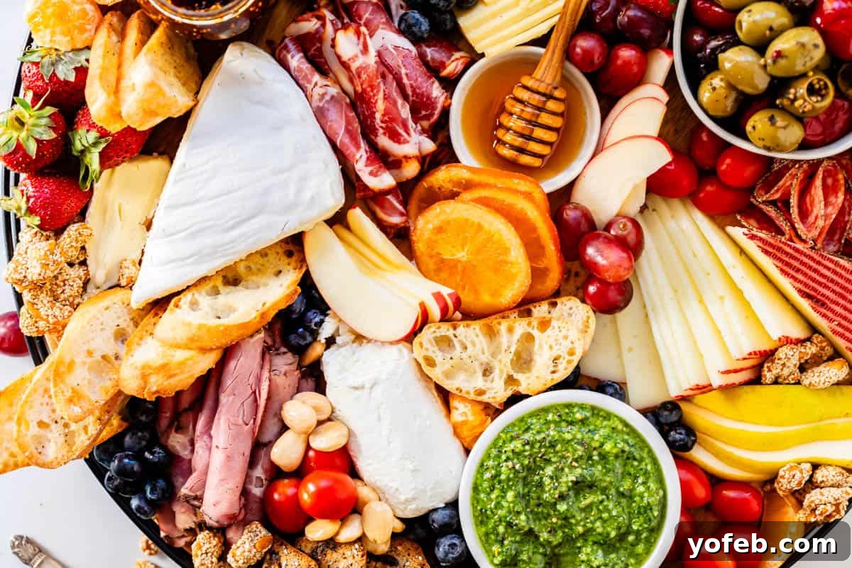 Crafting the Perfect Charcuterie Board 27 Charcuterie board arranged with assortment of cheese, fruit, meats, nuts, sauces, spreads, bread, and crackers.
