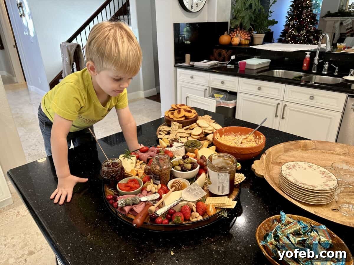 Crafting the Perfect Charcuterie Board 4 small boy leaning over charcuterie board.