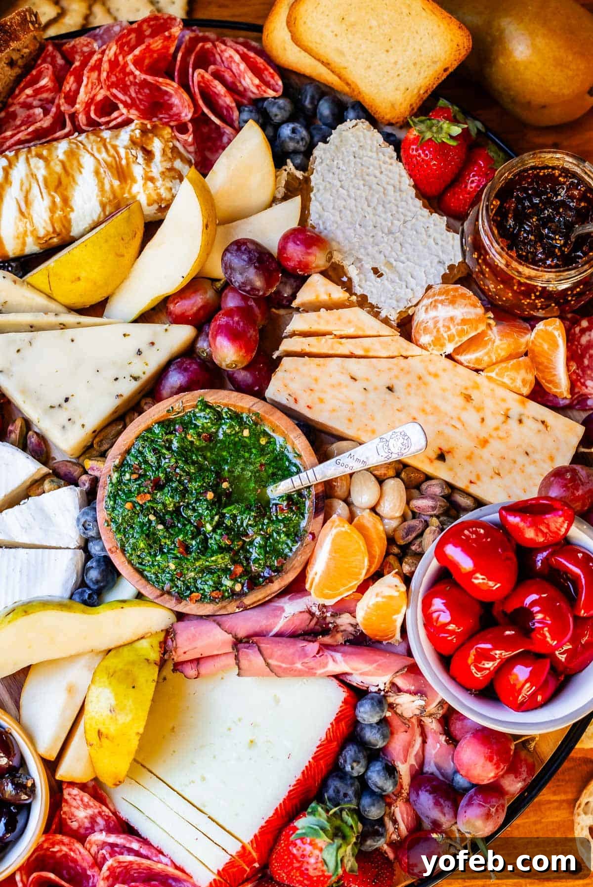 Crafting the Perfect Charcuterie Board 31 chimichurri on a charcuterie board with cheese, peppers, grapes.