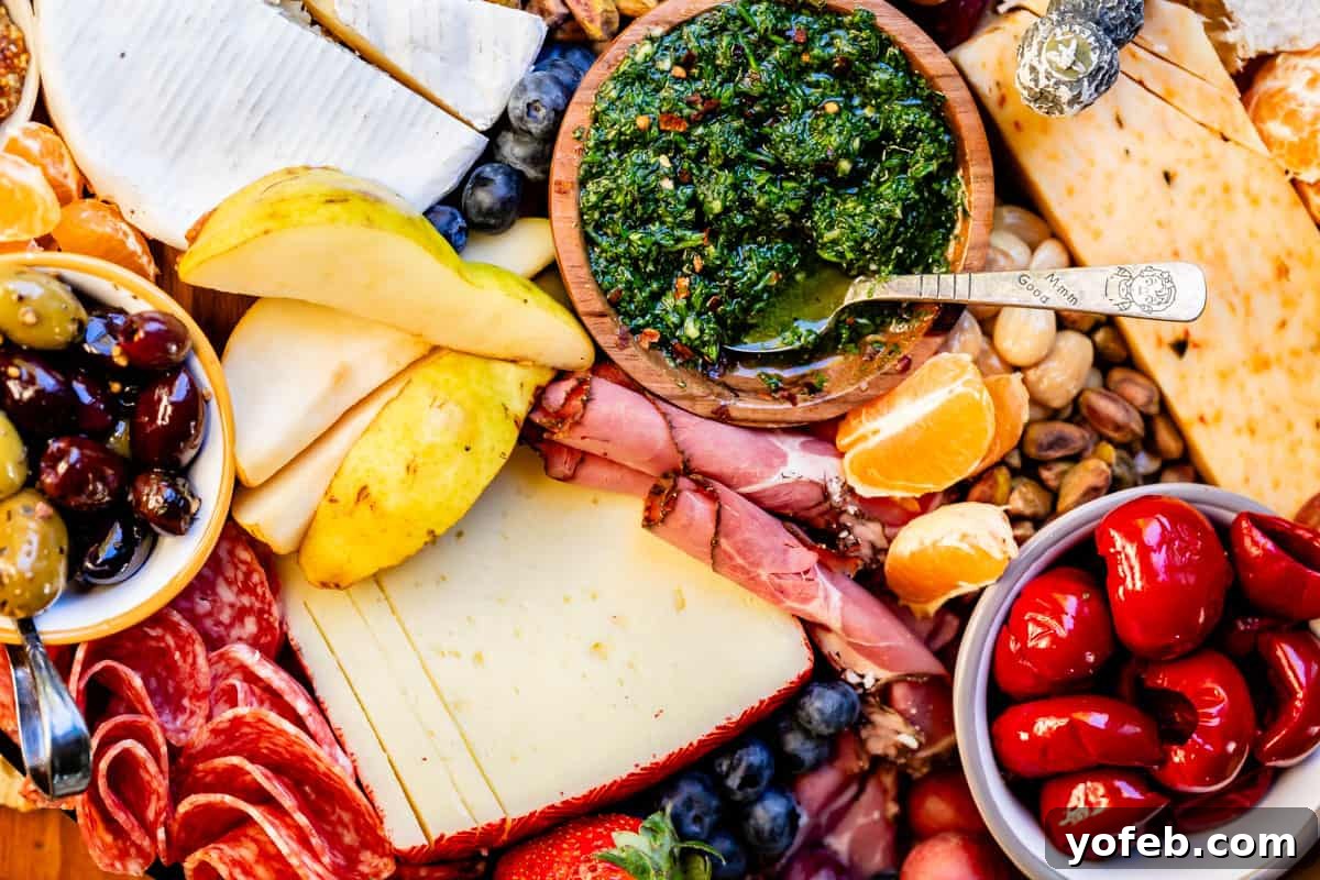 Crafting the Perfect Charcuterie Board 9 pears, chimichurri, mandarin, peppers, and cheese on a charcuterie board.