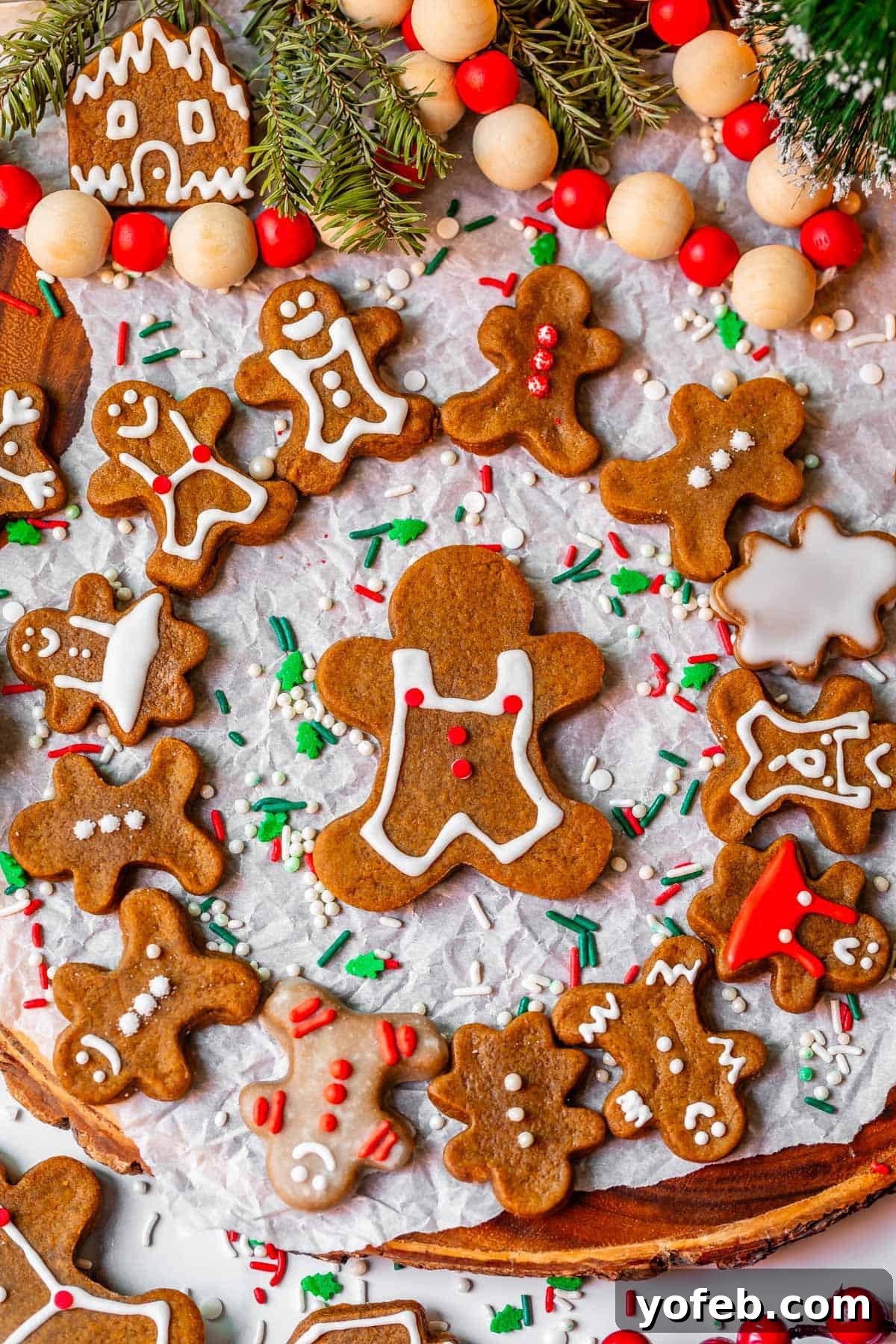 Perfectly Soft Chewy Gingerbread Men That Hold Their Shape 3 A circular arrangement of small gingerbread men cookies surrounding a larger gingerbread man, all perfectly shaped and ready for decorating.