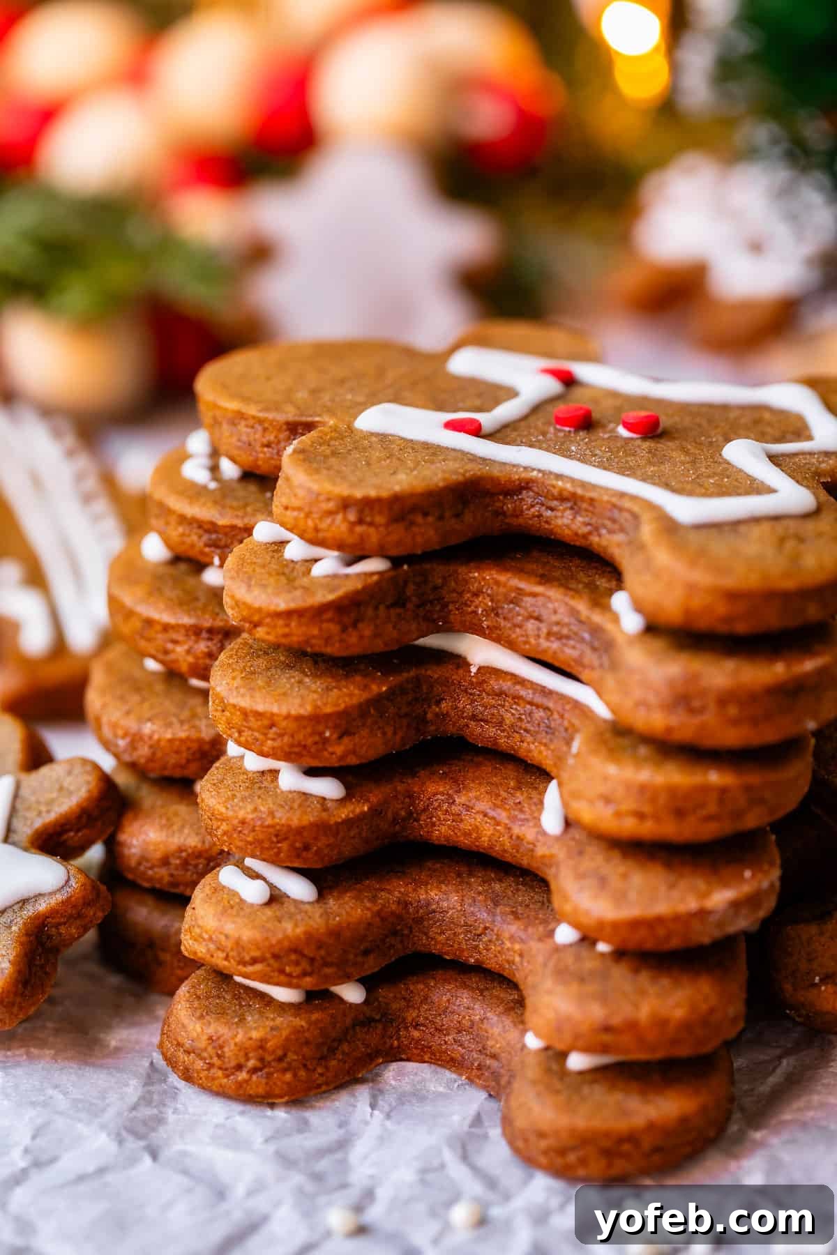 Perfectly Soft Chewy Gingerbread Men That Hold Their Shape 31 A beautiful stack of gingerbread men cookies adorned with intricate royal icing designs, ready for the holidays.