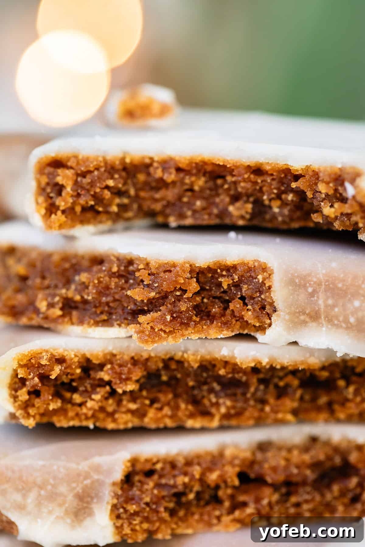Perfectly Soft Chewy Gingerbread Men That Hold Their Shape 4 A close-up of a perfectly glazed gingerbread cookie, broken in half to reveal its soft, moist interior.