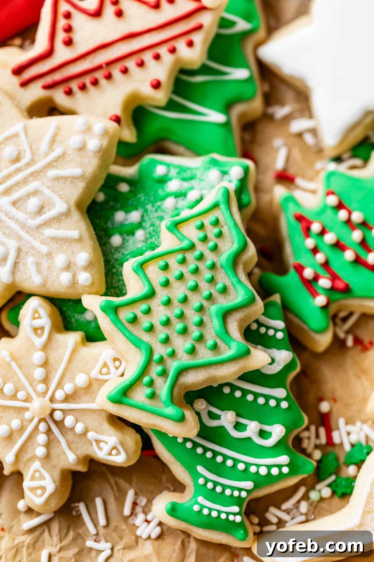 Beginner's Guide to Perfect Royal Icing 36 Decorated Christmas holiday cookies including tree, snowflake, and stars.