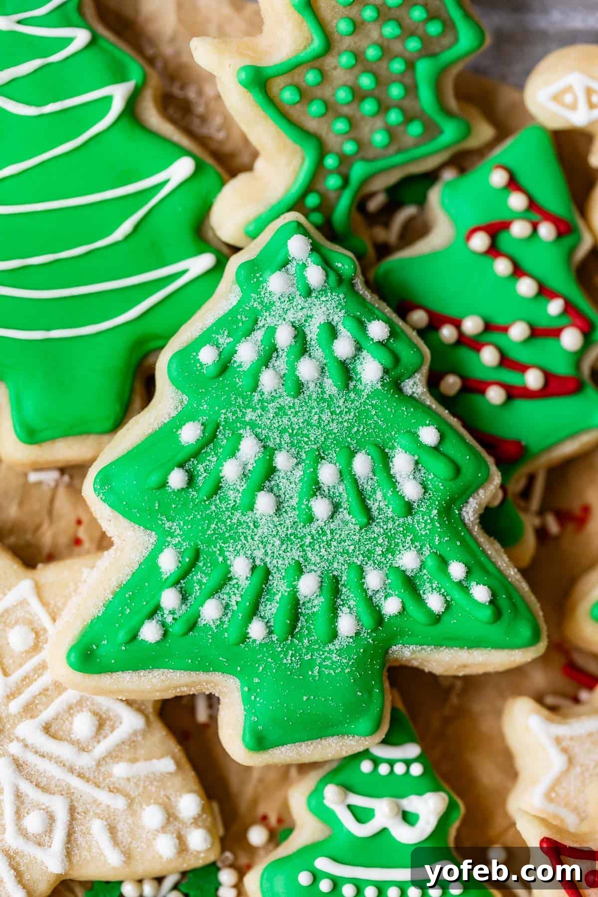 Beginner's Guide to Perfect Royal Icing 37 Christmas sugar cookies with royal icing designs including green frosting and sugar snow.