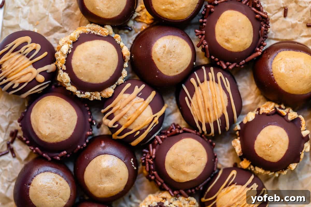 Irresistible Buckeye Ball Recipe 25 Buckeye balls drizzled with peanut butter on parchment paper.