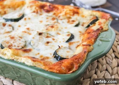 Southwestern Vegetable Lasagna 5 A perfectly portioned slice of creamy Poblano, Corn, and Zucchini Lasagna on a plate.