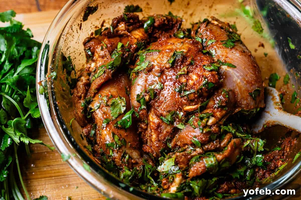 My Chicken Fajitas Awakening 12 glass bowl with chicken thighs in marinade with cilantro added.