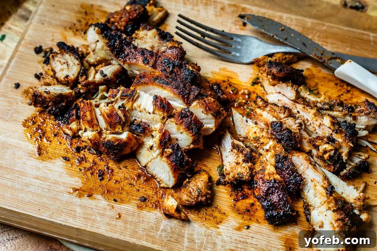 My Chicken Fajitas Awakening 16 freshly sliced cooked chicken fajita breast with a fork and knife on a wooden cutting board.