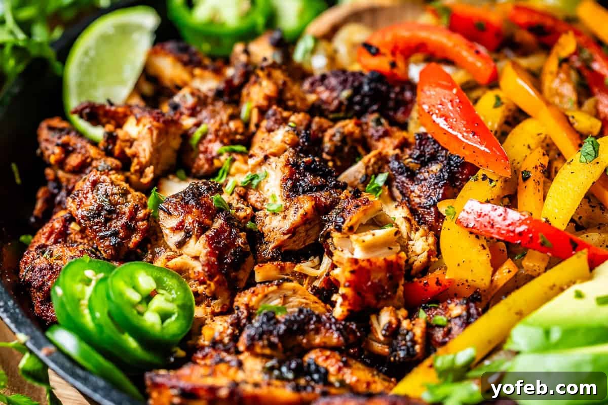 My Chicken Fajitas Awakening 6 looking closely at charred fajita chicken, with lime and jalapeno slices as garnish.