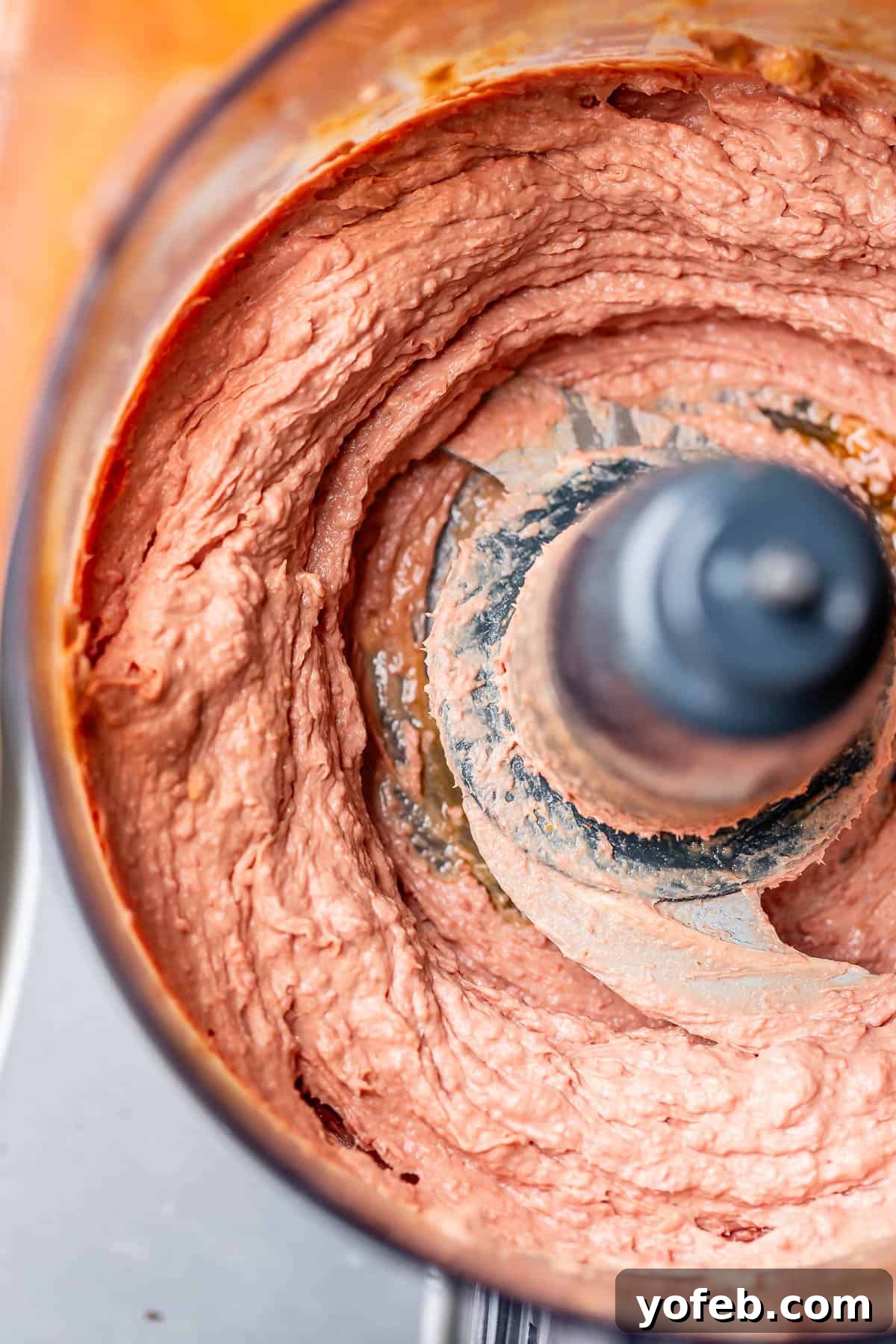 Smooth, blended pâté glistening inside a food processor bowl, ready to be scraped out and served.