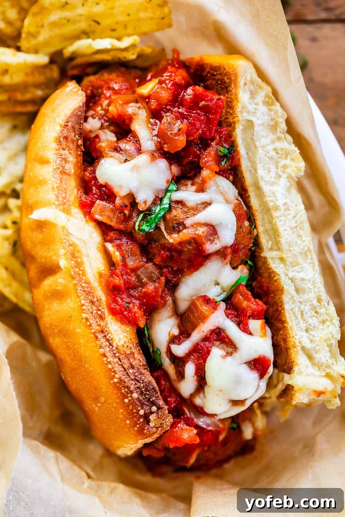 Laura's Ultimate Meatball Sub 2 A perfectly toasted sub roll generously filled with succulent meatballs simmered in a rich, homemade marinara sauce, all topped with a generous layer of melted, gooey cheese, ready to be devoured.
