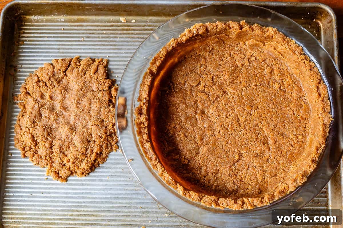 Luscious Caramel Swirled Coconut Cream Pie 15 crust in pie plate on metal baking sheet, with extra crust on side to be baked for topping.
