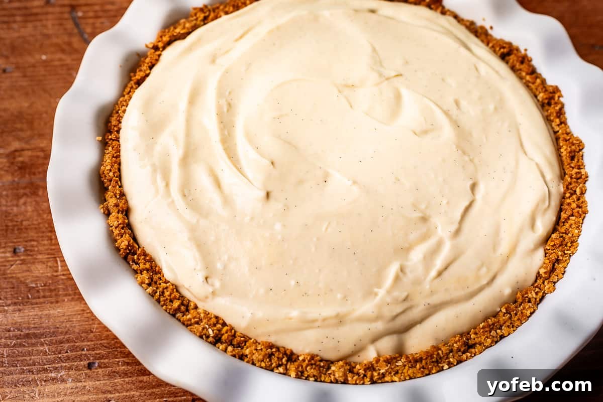 Luscious Caramel Swirled Coconut Cream Pie 19 coconut filling spread evenly inside a crust in a ceramic pie plate.