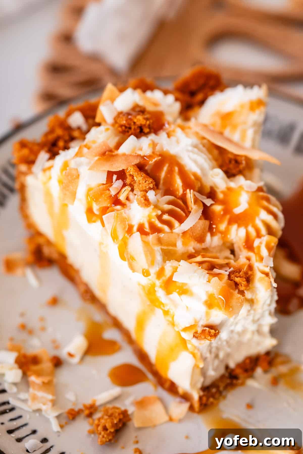Luscious Caramel Swirled Coconut Cream Pie 5 slice of coconut cream pie with white chocolate garnish and caramel drizzle.
