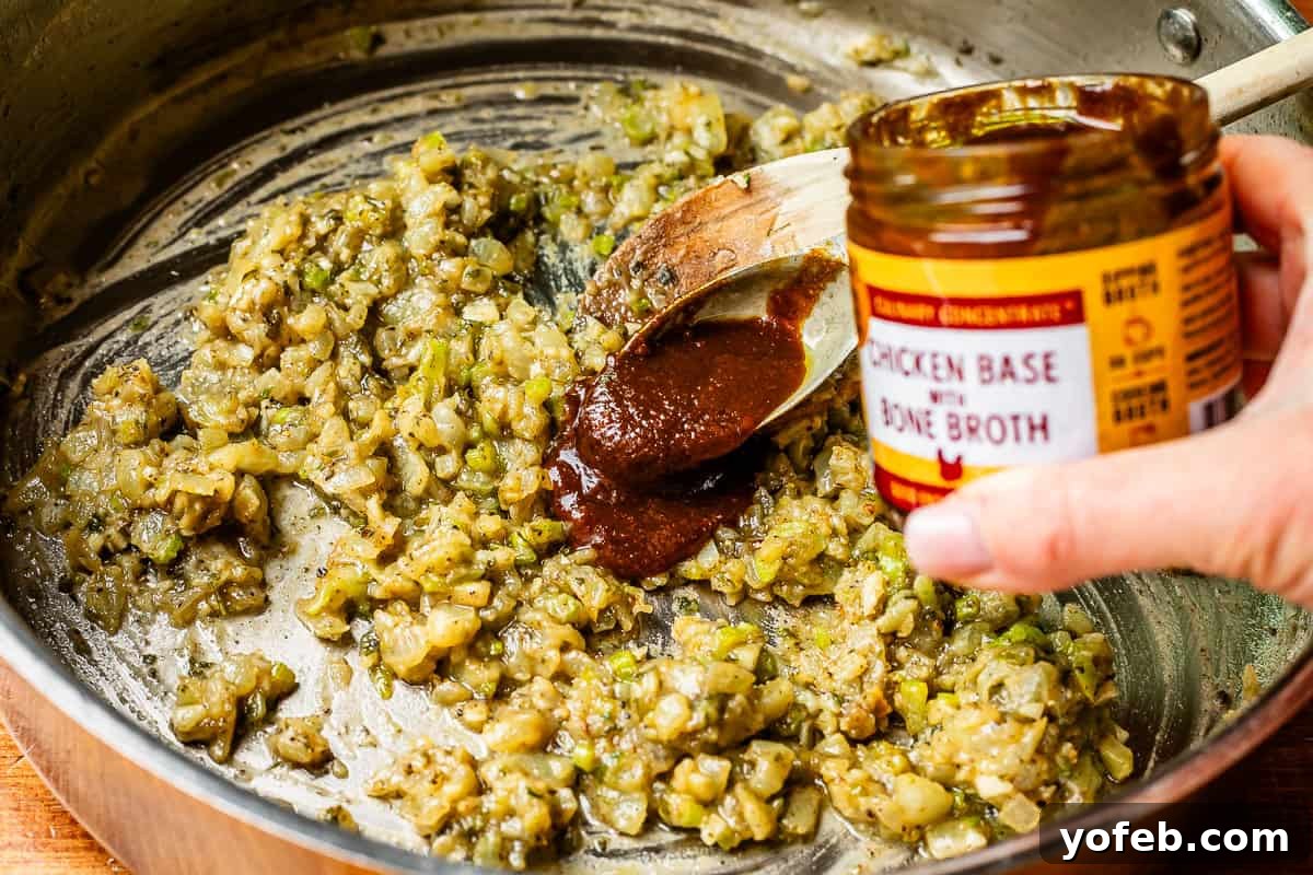 Grandma Georgia's Homestyle Chicken and Rice Bake 15 A generous spoonful of Zoup! Chicken Bone Broth Culinary Concentrate is added to a skillet containing flour-coated vegetables, enriching the base for the casserole's homemade sauce.