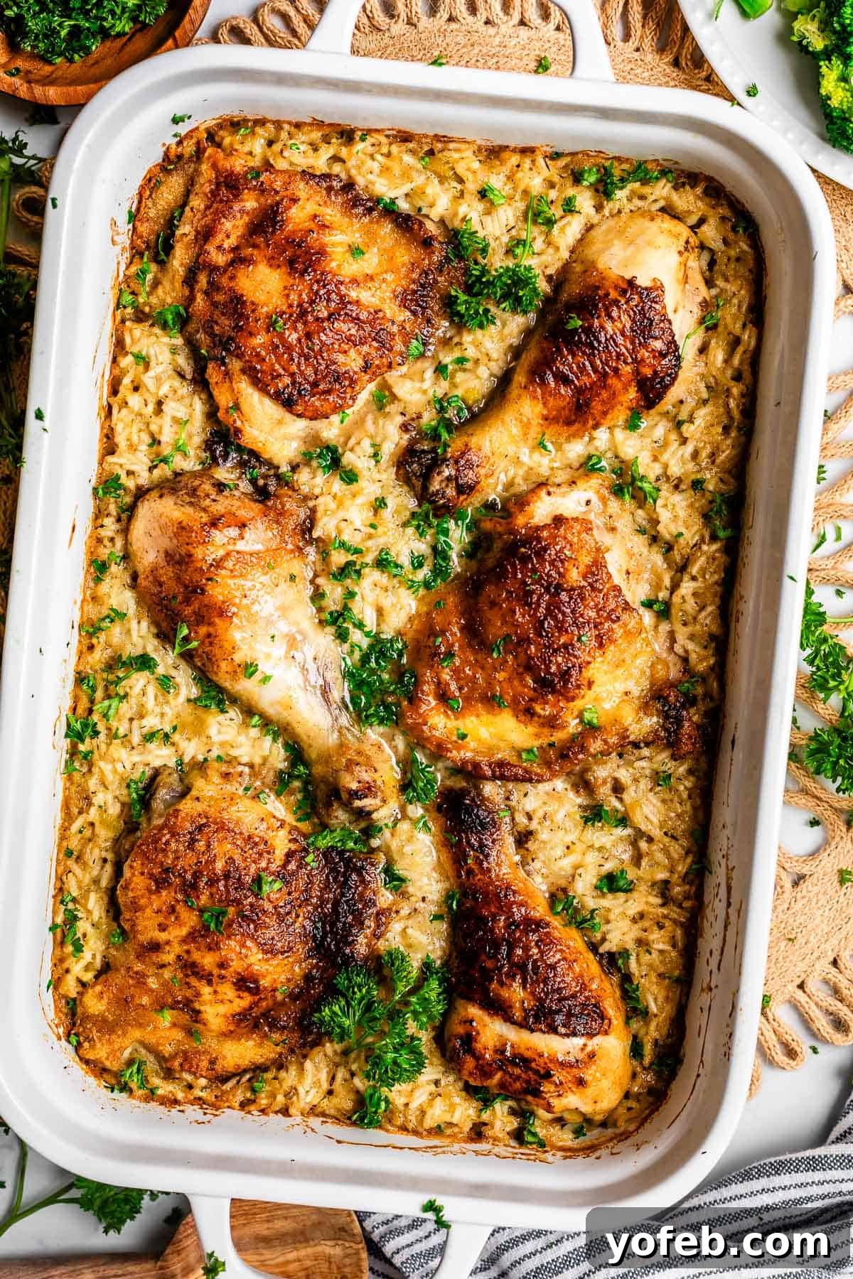 Grandma Georgia's Homestyle Chicken and Rice Bake 18 A top-down view of a golden-brown chicken and rice casserole, baked to perfection in a classic 9x13 ceramic dish, showcasing its rich texture and comforting appeal.