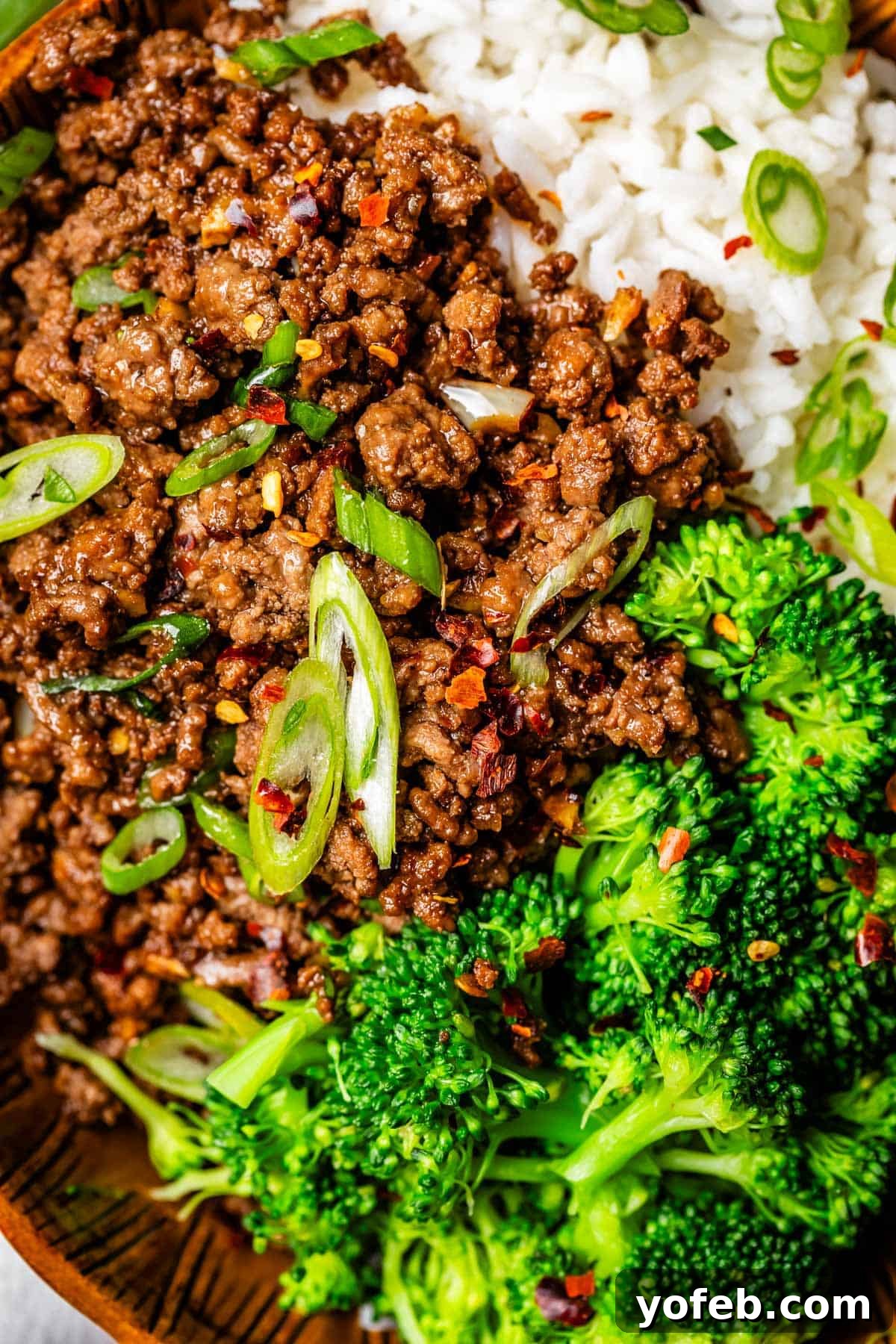 Easy 30-Minute Korean Beef 14 A delightful ceramic bowl filled with fluffy rice, savory Korean beef, and tender broccoli florets, creating a balanced and appealing meal.