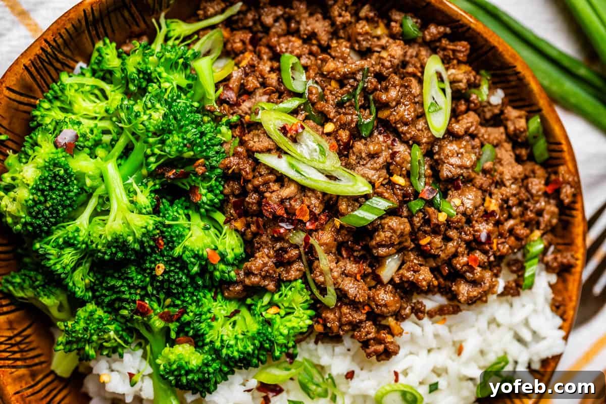 Easy 30-Minute Korean Beef 7 A close-up of a serving of Korean beef alongside perfectly cooked broccoli florets, garnished with fresh green onions, showcasing a delicious and balanced meal.