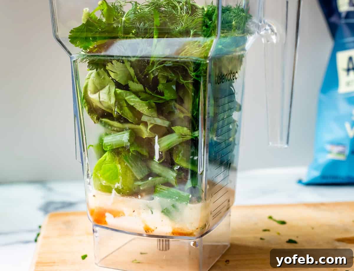 The Ultimate Green Goddess Salad 10 blender with several green goddess ingredients layered inside.