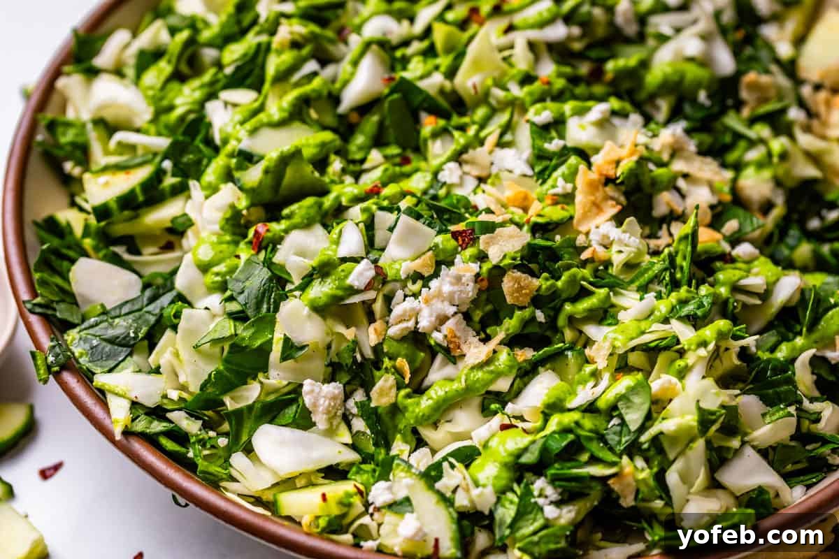 The Ultimate Green Goddess Salad 16 close up of green goddess salad on a plate and topped with dressing and salt & vinegar chips.