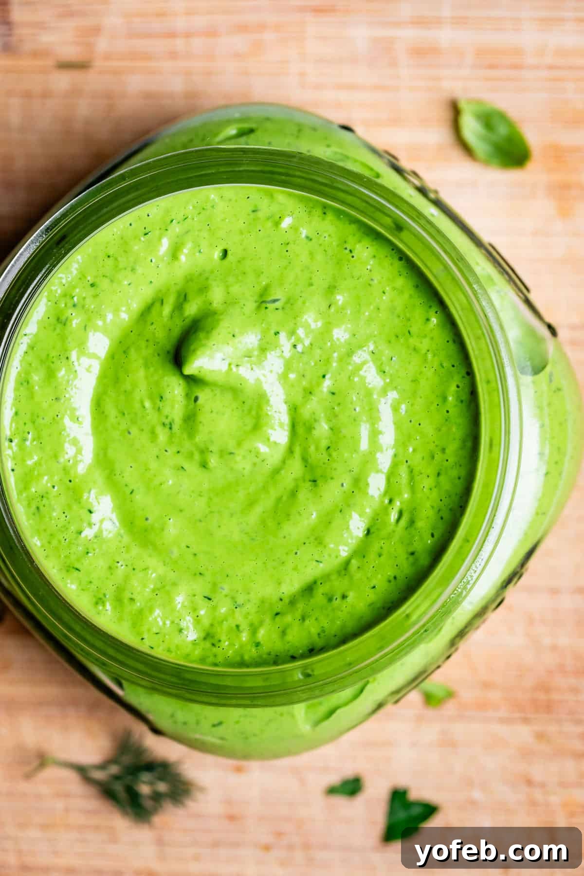 The Ultimate Green Goddess Salad 6 overhead shot of green goddess dressing swirled in a mason jar.
