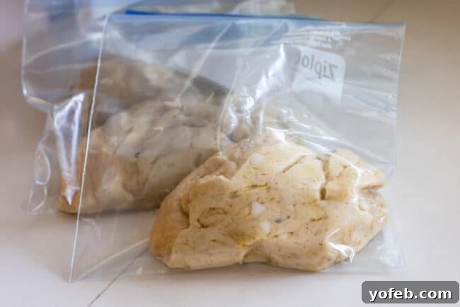 Frozen Liege Waffle Dough Portions Individual balls of Liege waffle dough, each with pearl sugar mixed in, neatly stored in separate plastic bags for freezing.