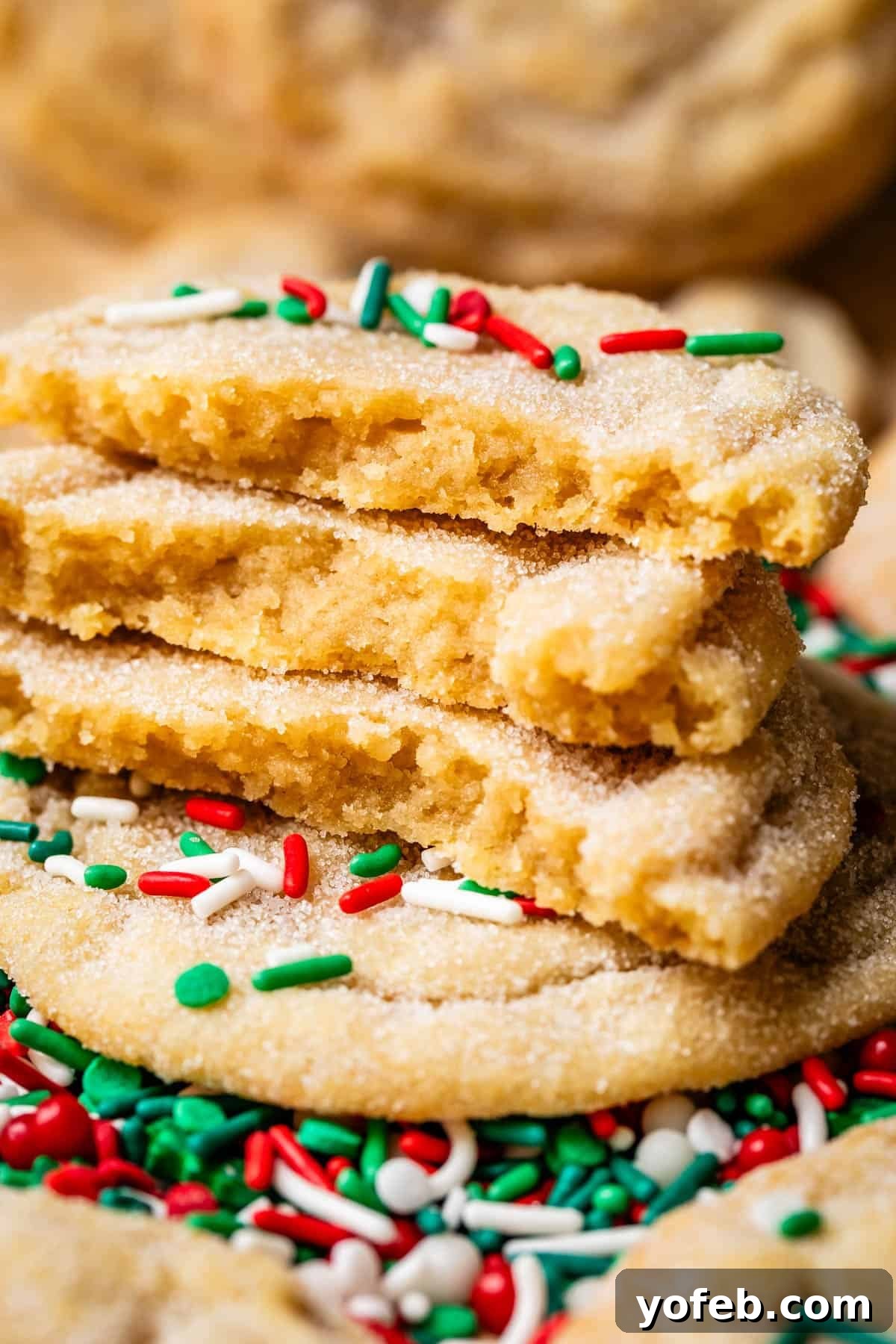 No Roll Chewy Sugar Cookies 30 Minute Recipe 18 Three halved drop sugar cookies stacked, topped with festive Christmas-colored sprinkles.