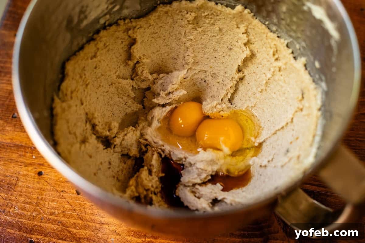 No Roll Chewy Sugar Cookies 30 Minute Recipe 10 Eggs added to the creamed butter and sugars in a metal mixing bowl, ready to be mixed.