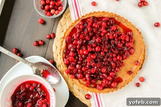 Nutty Brown Butter Cranberry Tart 4 An overhead shot of the browned butter cranberry tart on a festive table setting.