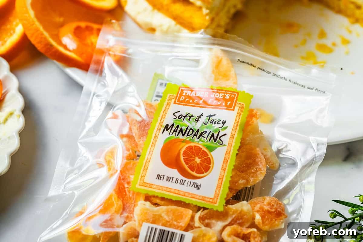 Golden Pineapple Mandarin Cake 17 package of trader joes "soft & juicy mandarins" on top of a countertop with plated cake behind it.