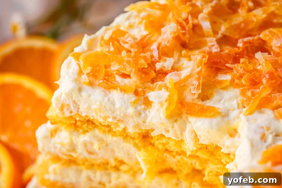 Golden Pineapple Mandarin Cake 18 close up of layered pig pickin cake with thinly chopped dried mandarin oranges on top.