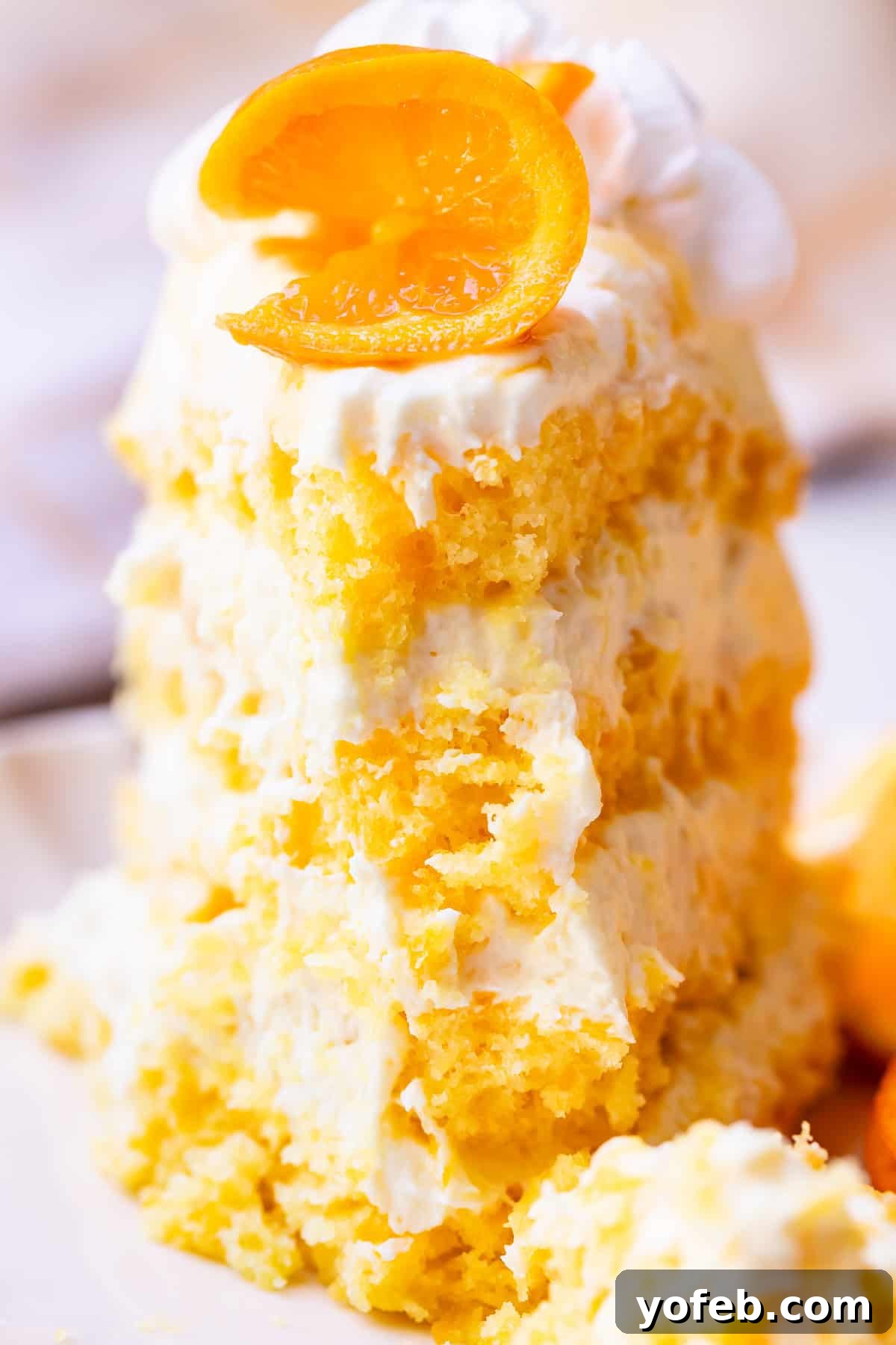 Golden Pineapple Mandarin Cake 5 looking straight at a piece of sunshine cake with the first bite taken.