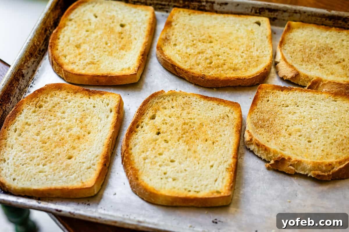 Vibrant Vegetable Stack 13 6 buttered and toasted slices of sourdough bread on a metal baking sheet.