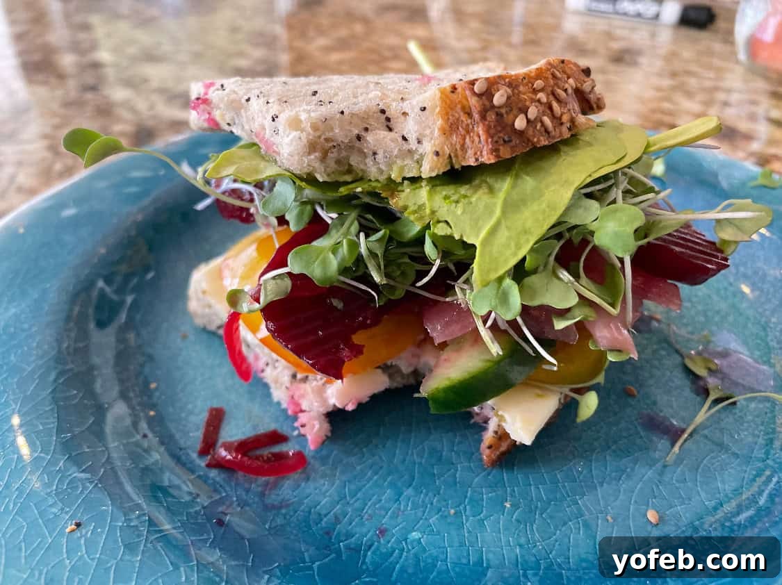 Vibrant Vegetable Stack 9 Veggie sandwich on a blue plate.