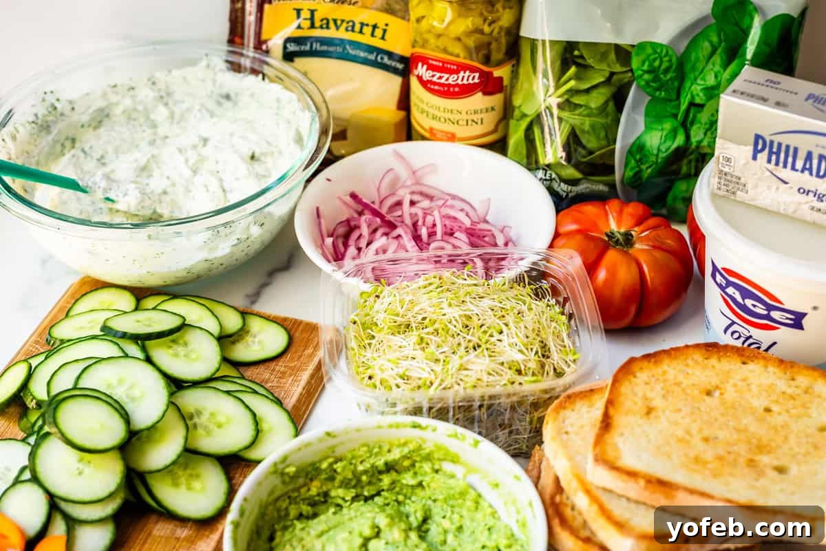 Vibrant Vegetable Stack 10 all ingredients for veggie sandwiches - spread, avocado, sourdough, and lots of veggies.