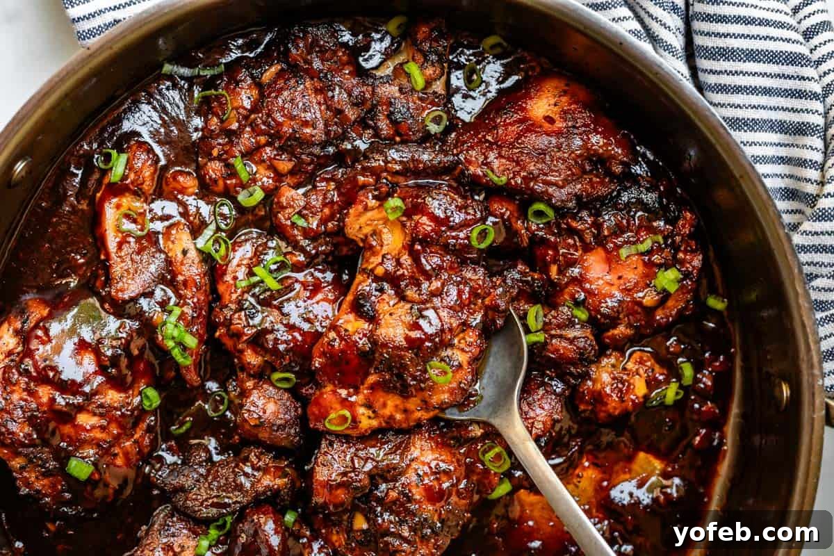 Easy Honey Garlic Chicken Slow Cooker Instant Pot 16 spoon serving from pot full of honey garlic chicken with green onion garnish.