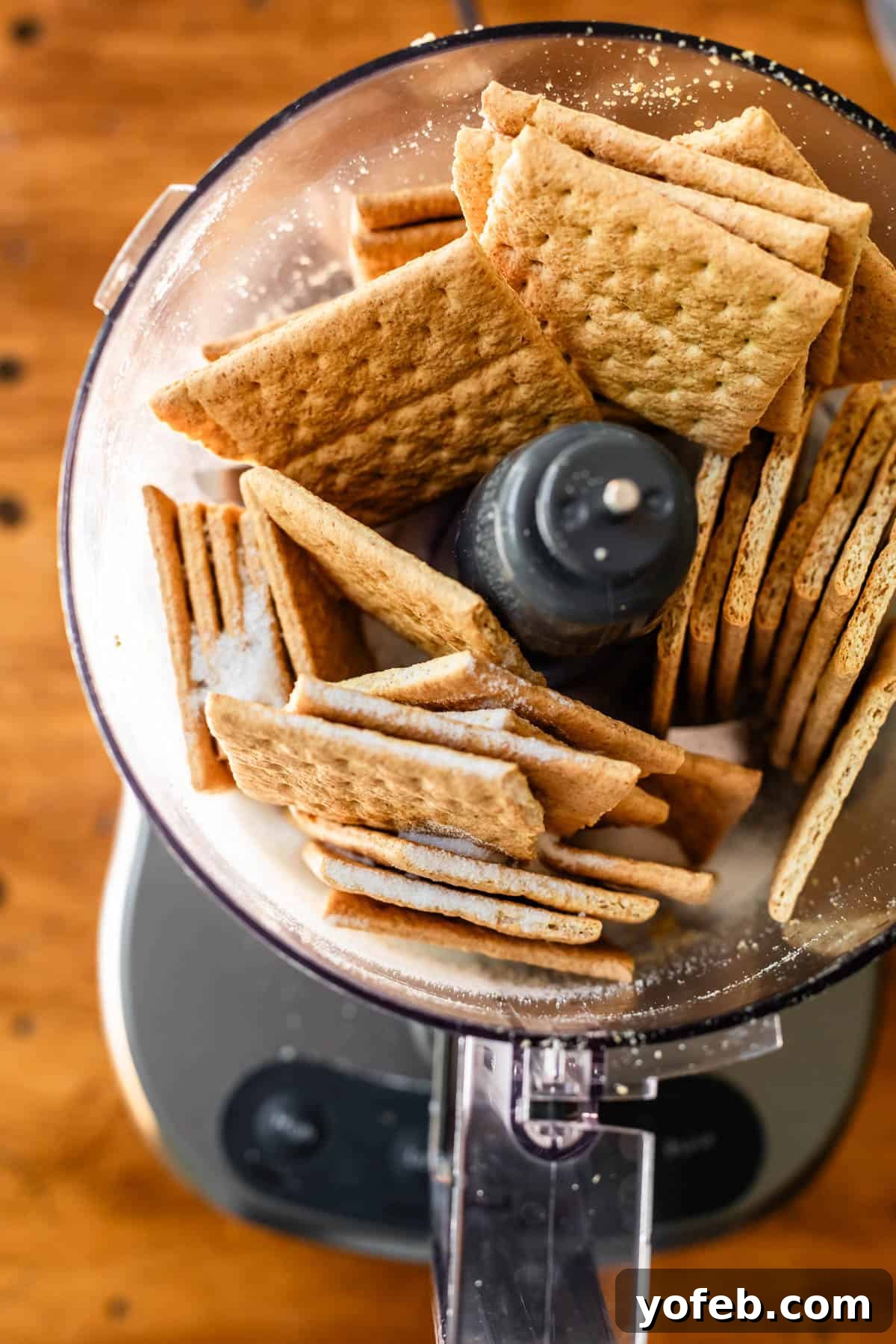 The Ultimate No Bake Cheesecake 17 9 whole graham crackers shoved into a food processor ready to be blitzed.